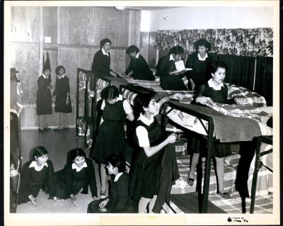 Photograph of girls in a dormitory