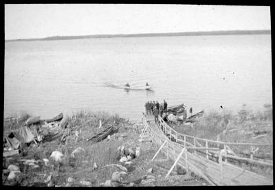 Photograph of a group standing on the shore at Albany River