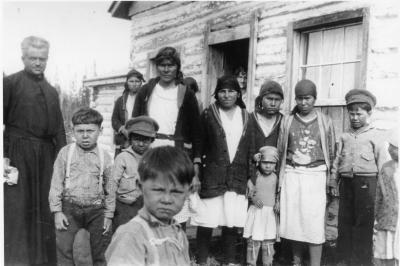 Photograph of women and children with a clergyman at Fort Albany