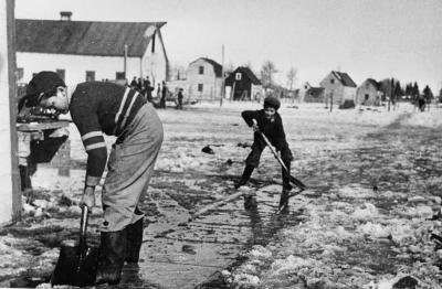 Photograph of boys tidying up outside