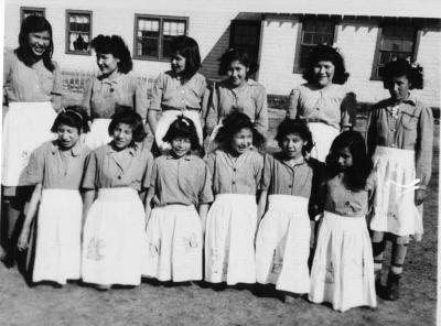 Photograph of young school girls in aprons