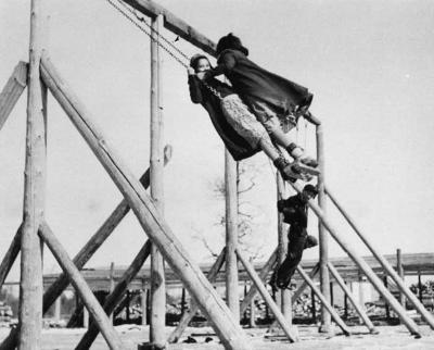 Photograph of children playing on swings