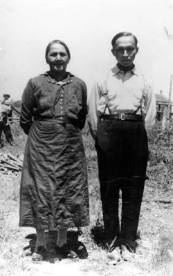 Photograph of Mary Ajawankwat and Moses Ajawankwat in a field