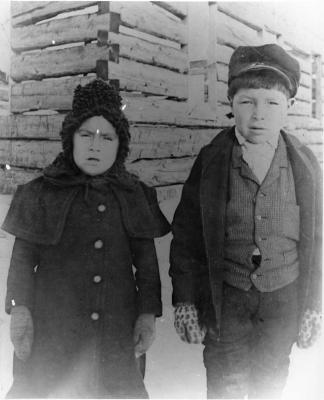 Photographs of two children outside at Wikwemikong
