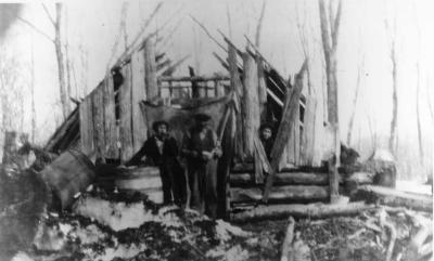 Photographs of three men outside at Wikwemikong