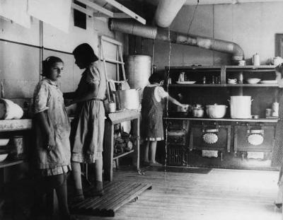 Moose Factory girls working in the kitchen