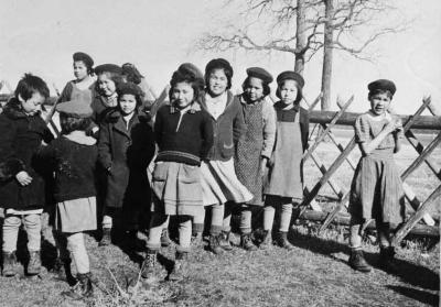 Photograph of students standing beside a fence