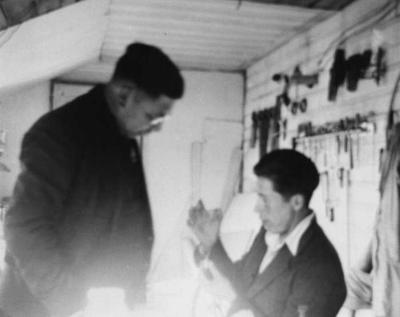 Photograph of men in a woodworking room