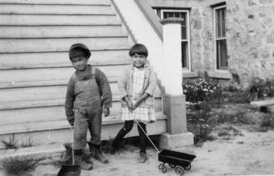Photograph of two junior students with toy wagons
