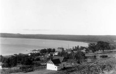 Photograph of houses and the lake at Wikwemikong
