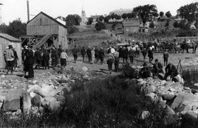 Photograph of people walking toward a church in Wikwemikong