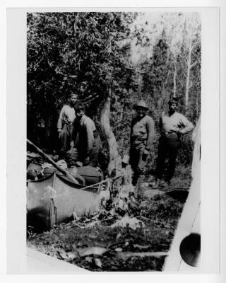 Photograph of four men in the forest at Fort Albany