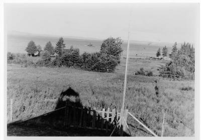 Photograph of a church yard near the water at Batchawana