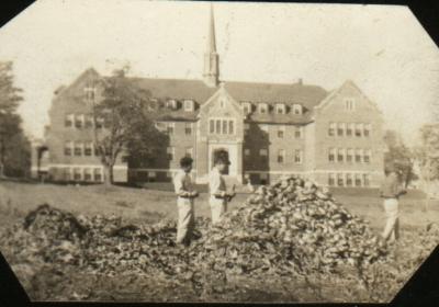 Photograph of three boys on the front lawn at Shingwauk Hall