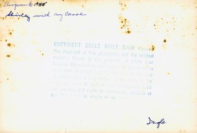 Photograph of Shirley Keywayosh with miniature canoe