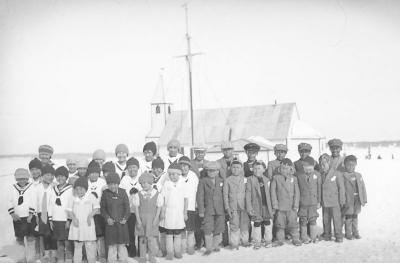 Photograph of children making snow people