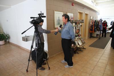 Photographs from Spanish Residential School reunion in auditorium and on-screen interview