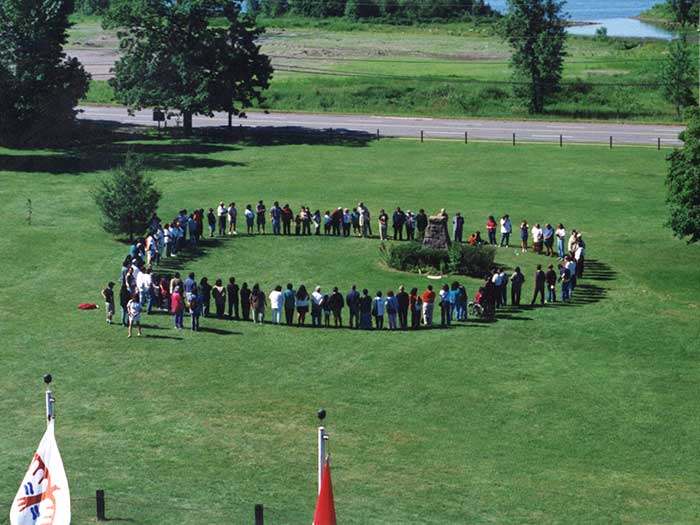 Circle of people in field